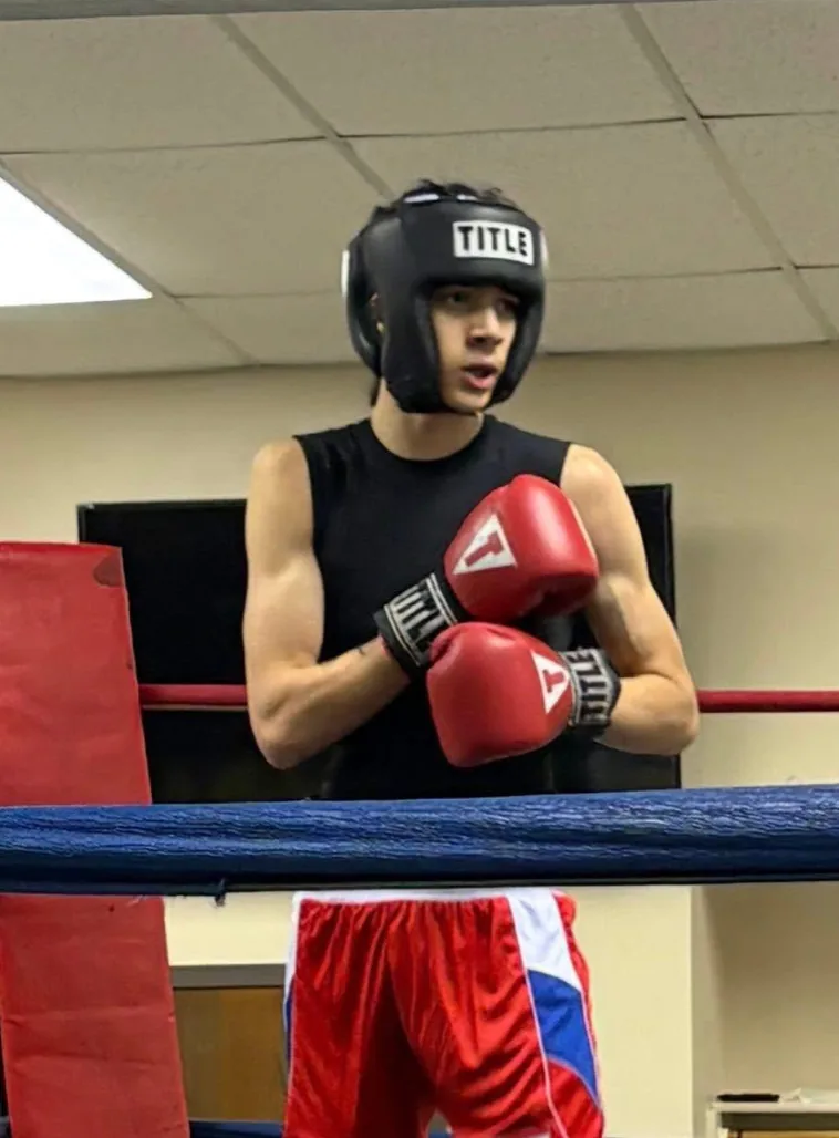 Romero's Boxing School athlete in headgear, ready in the ring