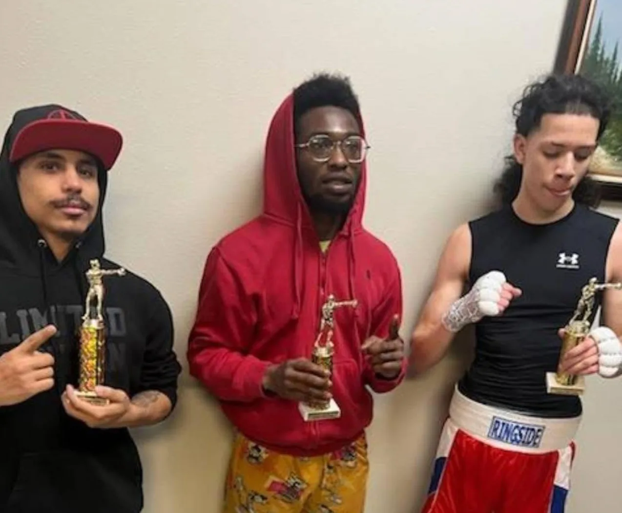Romero's Boxing School athletes holding trophies after a competition