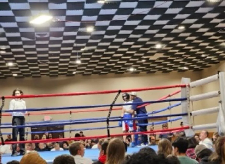 Coach working the corner with an athlete during a competition bout